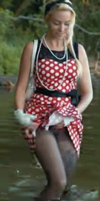 Pretty blond in pokadot dress playing in the water