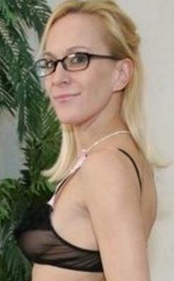 Erin Moore wearing glasses takes off black bra and panties